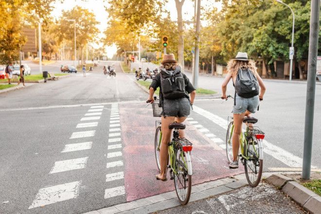 Cyclists crossing road intersection. Bicycle as urban transport
